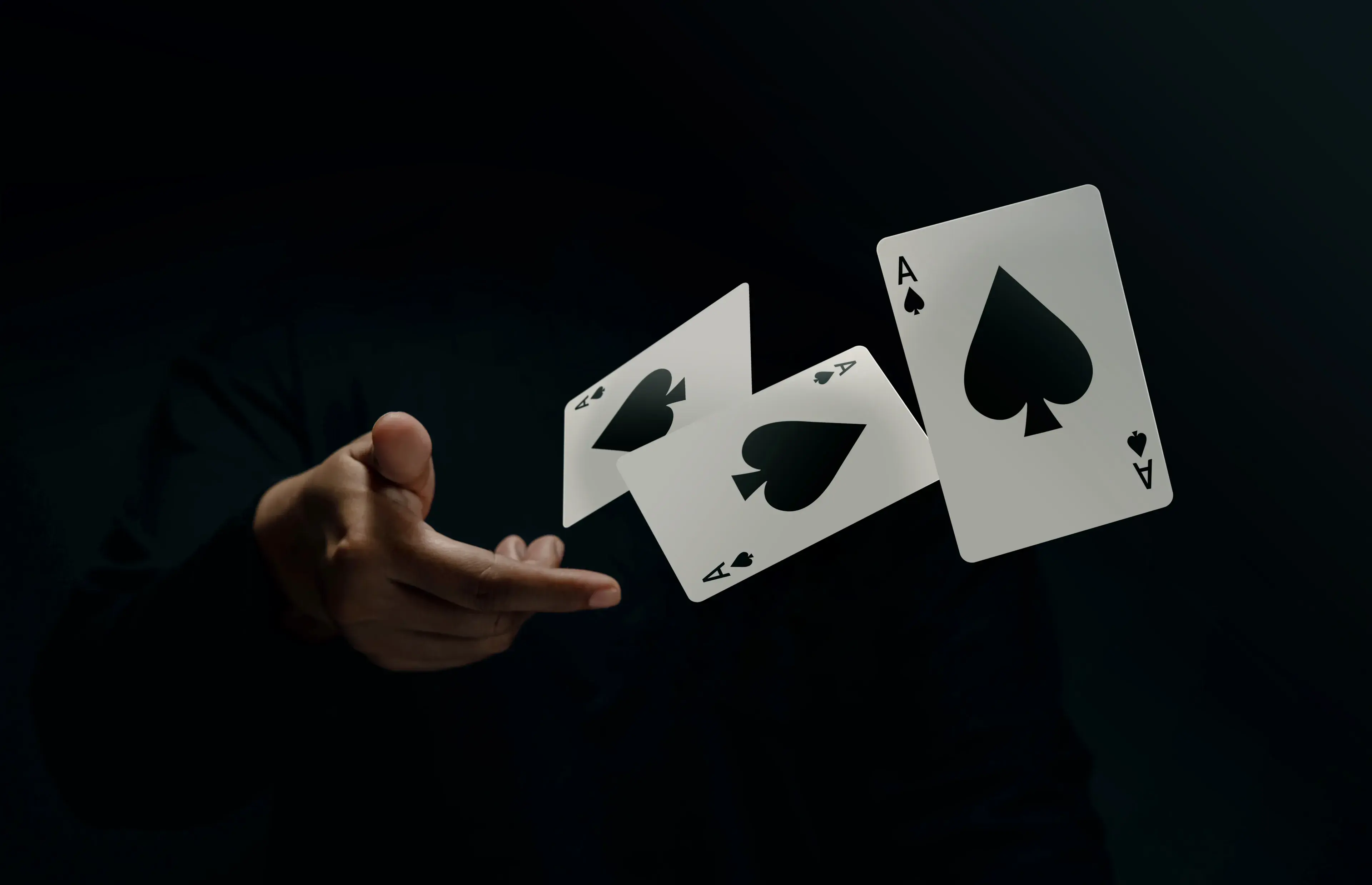 Ace Spade Playing Card. Player or Magician Throwing and Levitating Poker Card by Hand. Front View. Closeup and Dark Tone Ace Spade Playing Card. Player or Magician Throwing and Levitating Poker Card by Hand. Front View. Closeup and Dark Tone